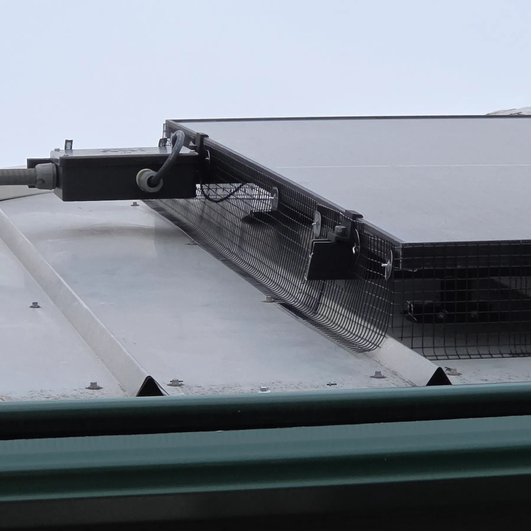 Close view of critter guard mesh fitted under the frame of a solar panel